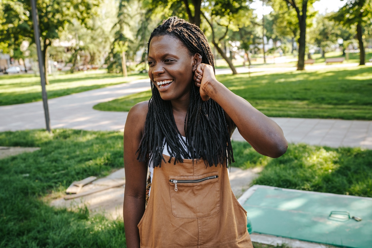 Happy woman in the park without allergies.