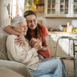 Daughter Assisting Senior Woman with Walker at home